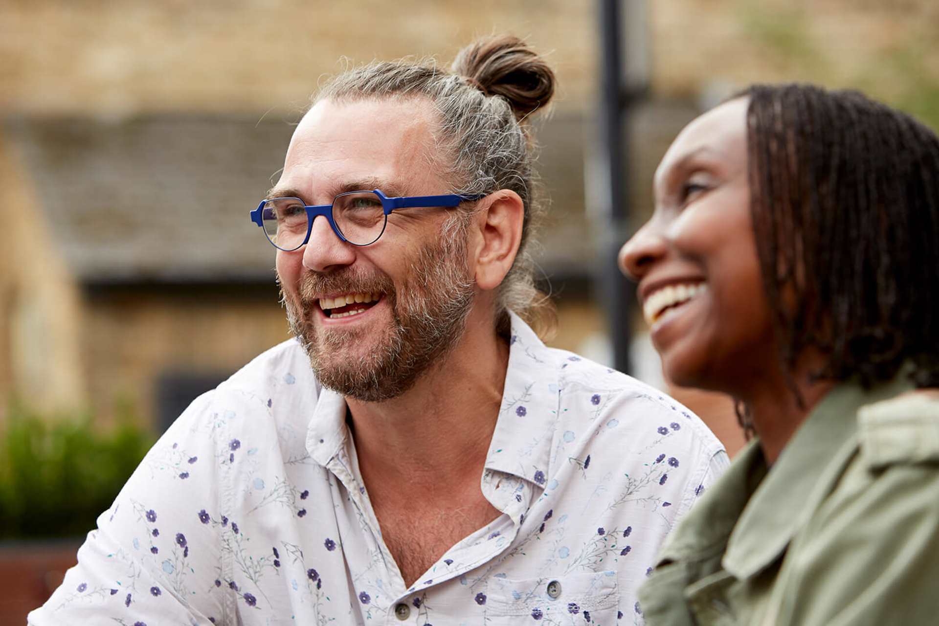 A happy couple laughing together outdoors