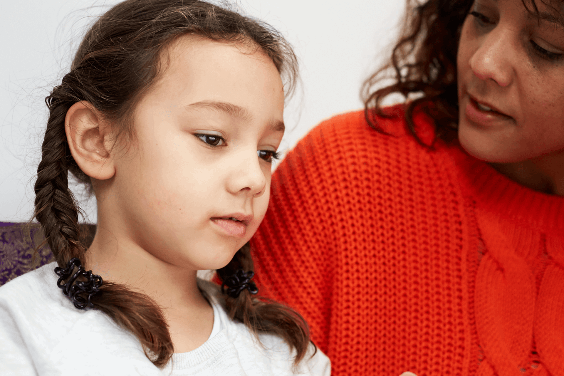 A mother and daughter talking on the sofa