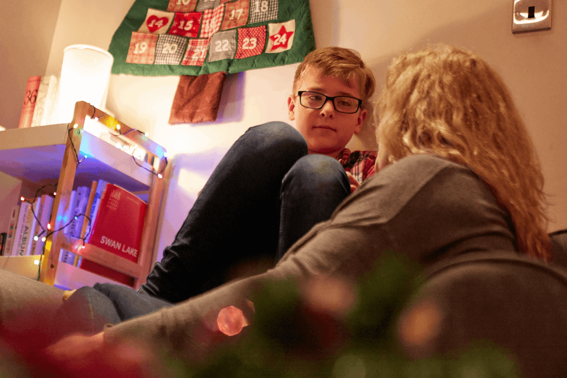 A mother in deep conversation with her young son in the lounge