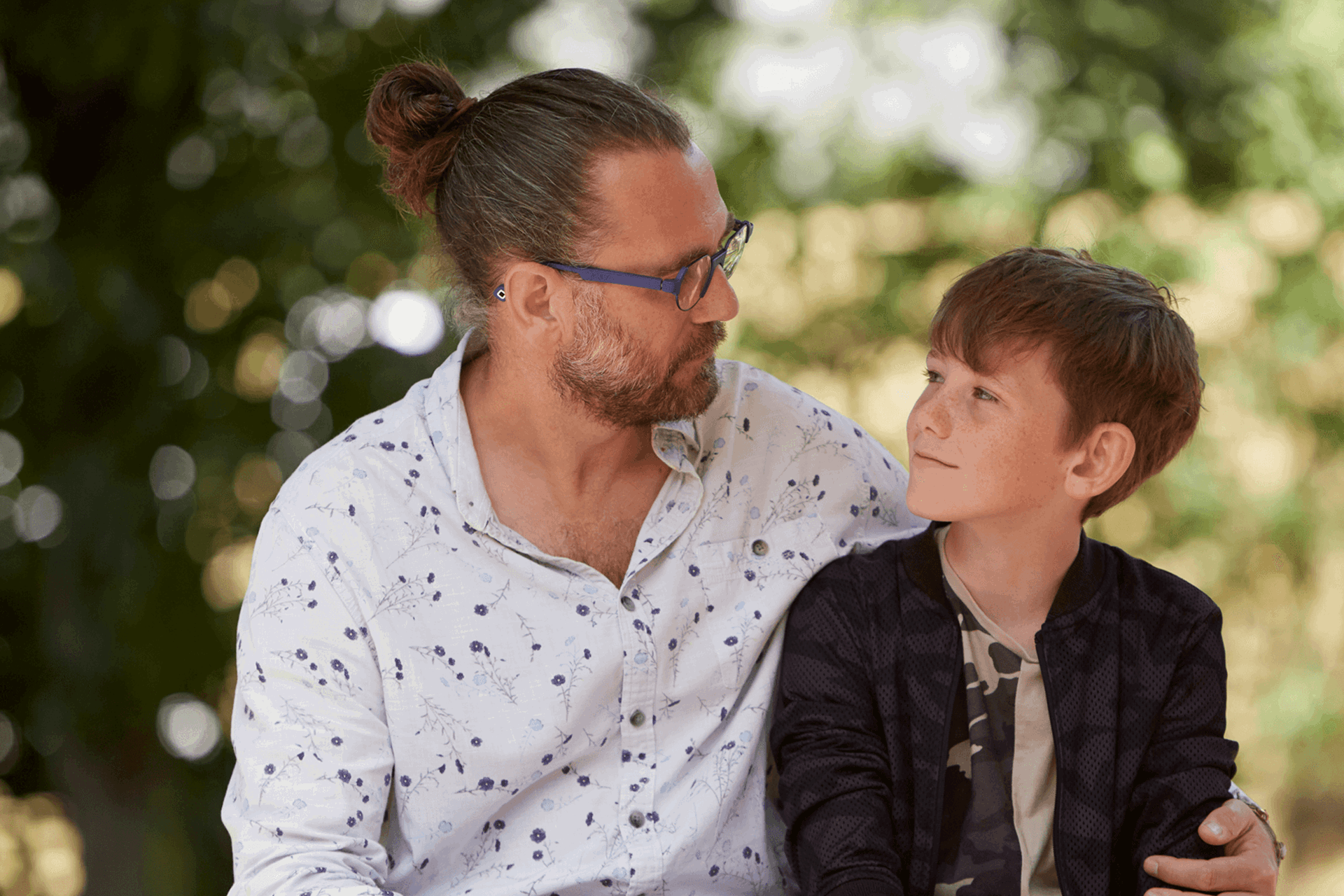 Father and son looking at each other lovingly 