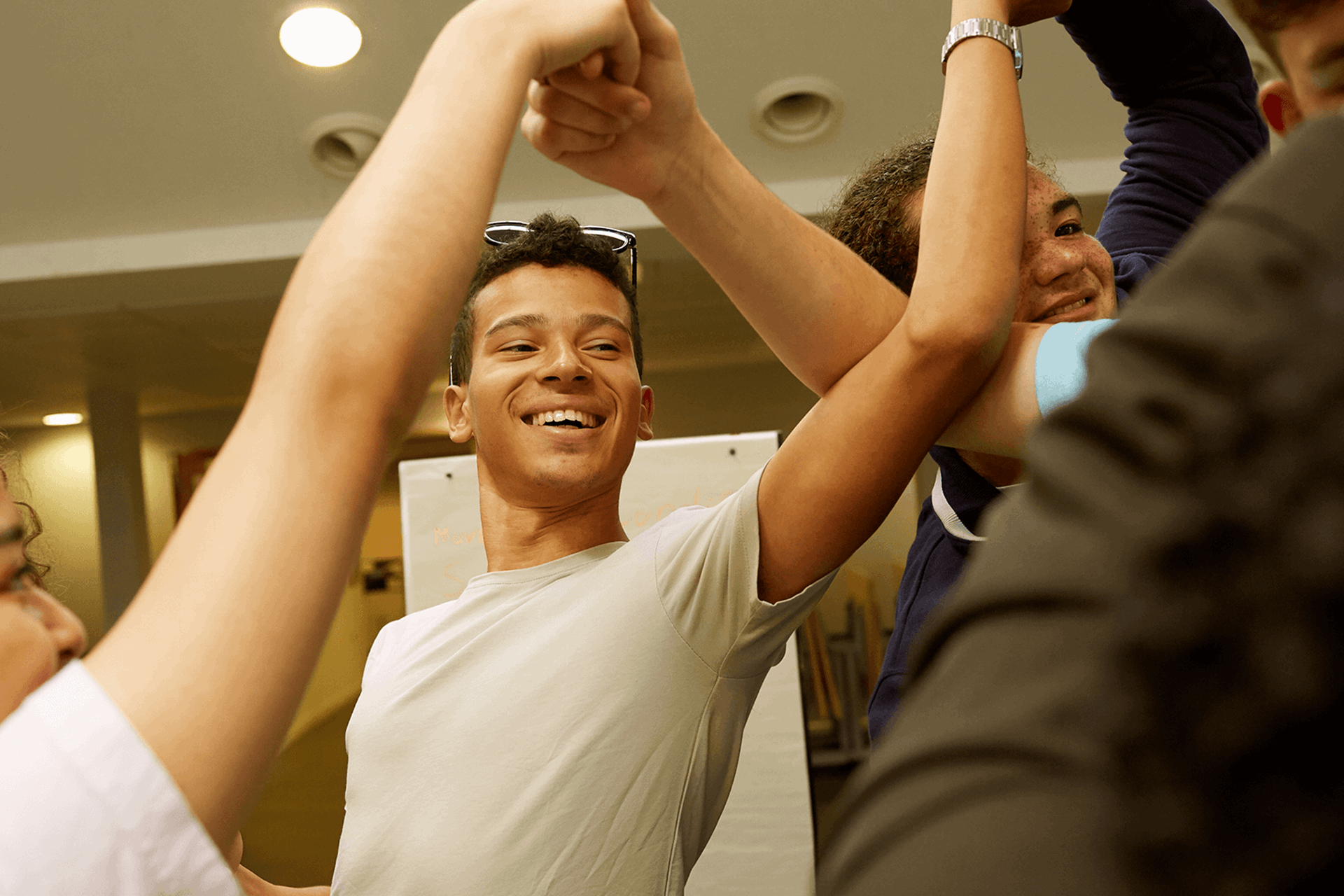 Four young people laughing and playing a game together.