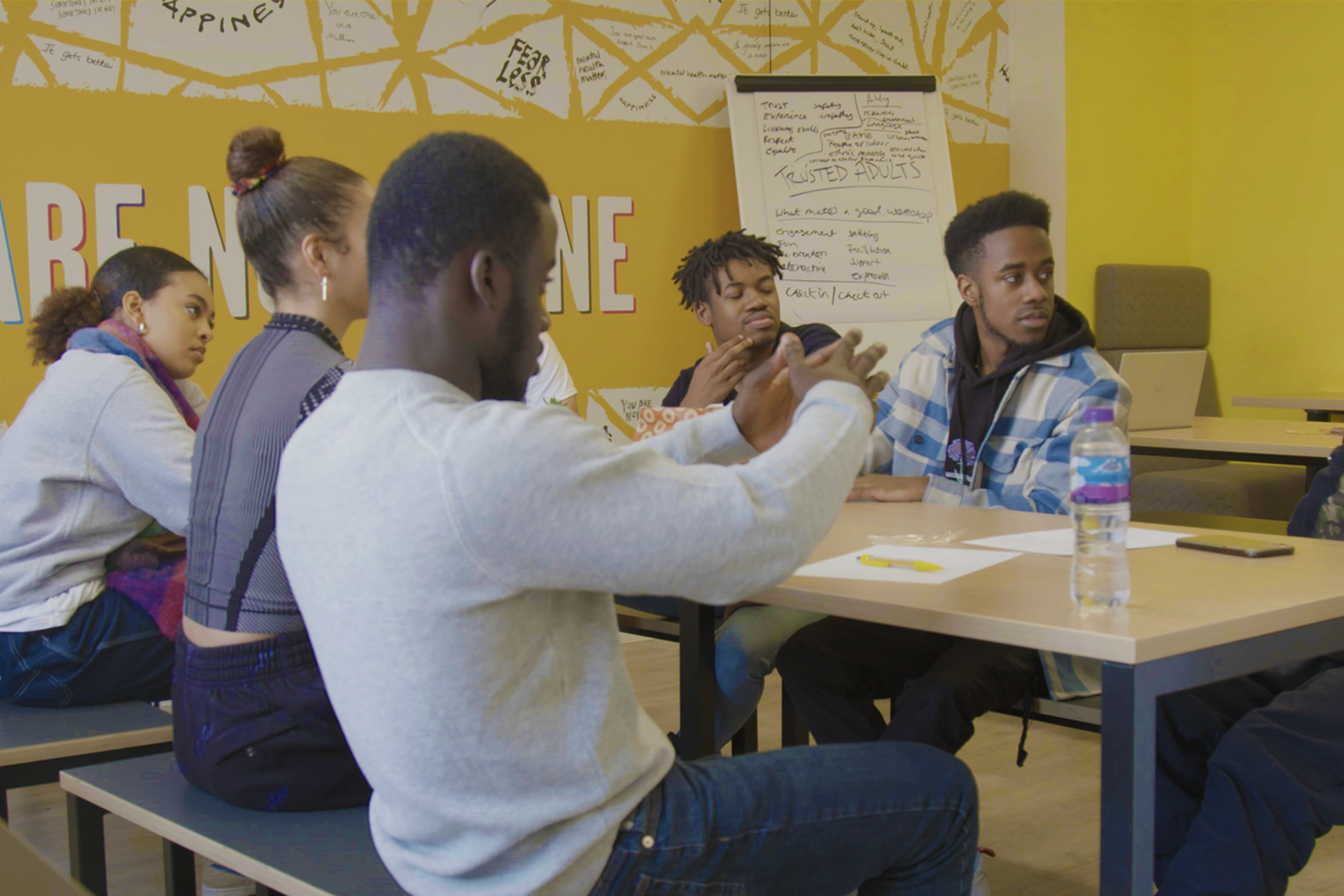 A group of young people discussing their poem ideas in the workshop.